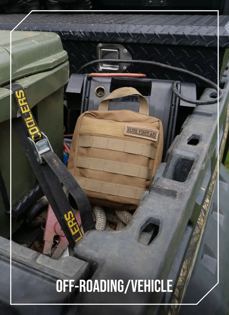 A tan tactical first aid kit with MOLLE webbing.